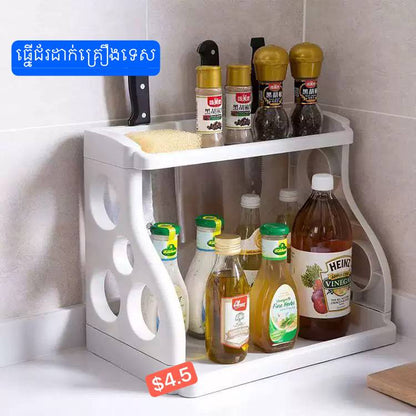 White two-tier kitchen organizer shelf holding sauces and spice bottles